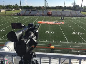 a video camera looking over an american football field
